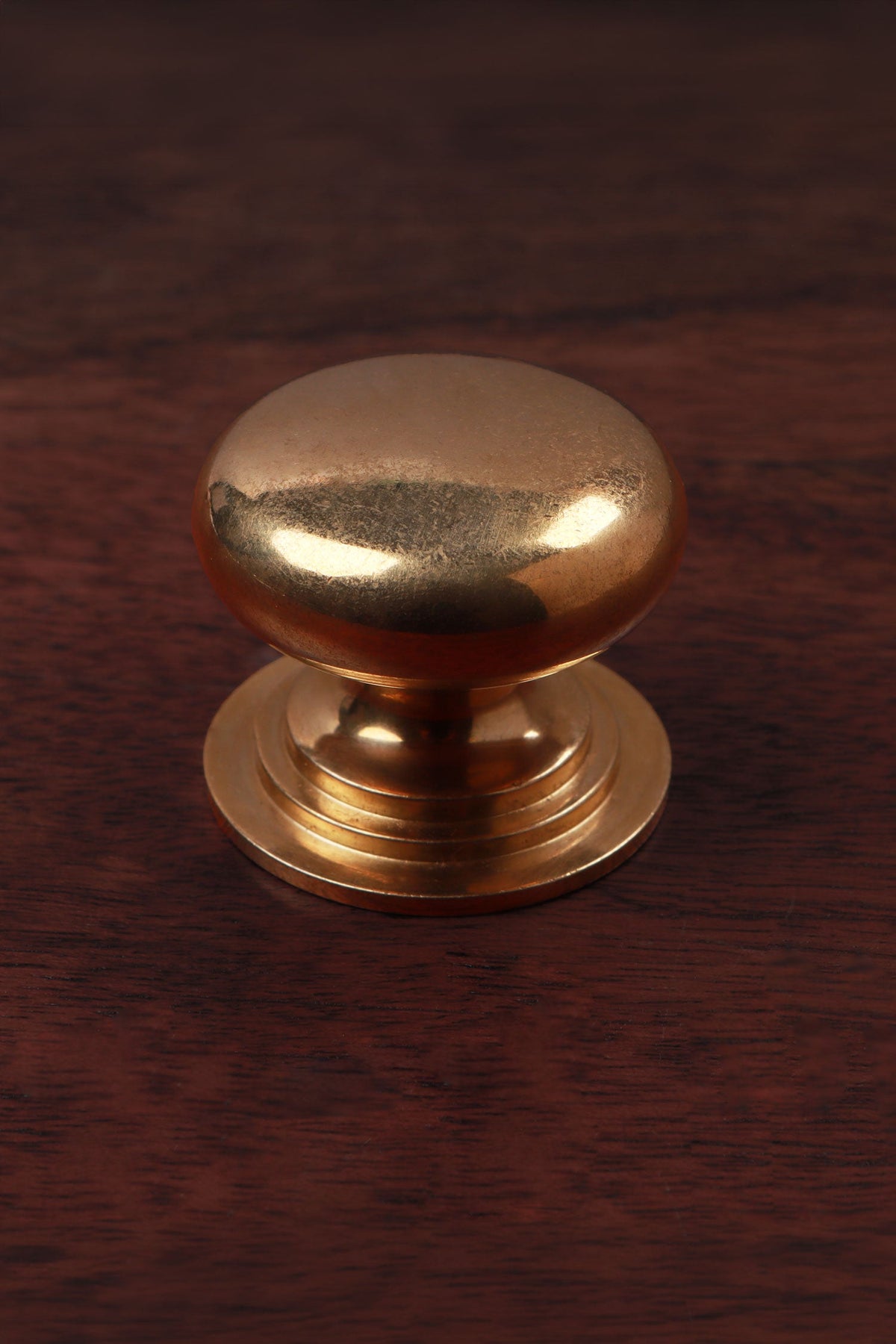 Victorian aged brass cabinet knob, domed on a stepped base, 38mm