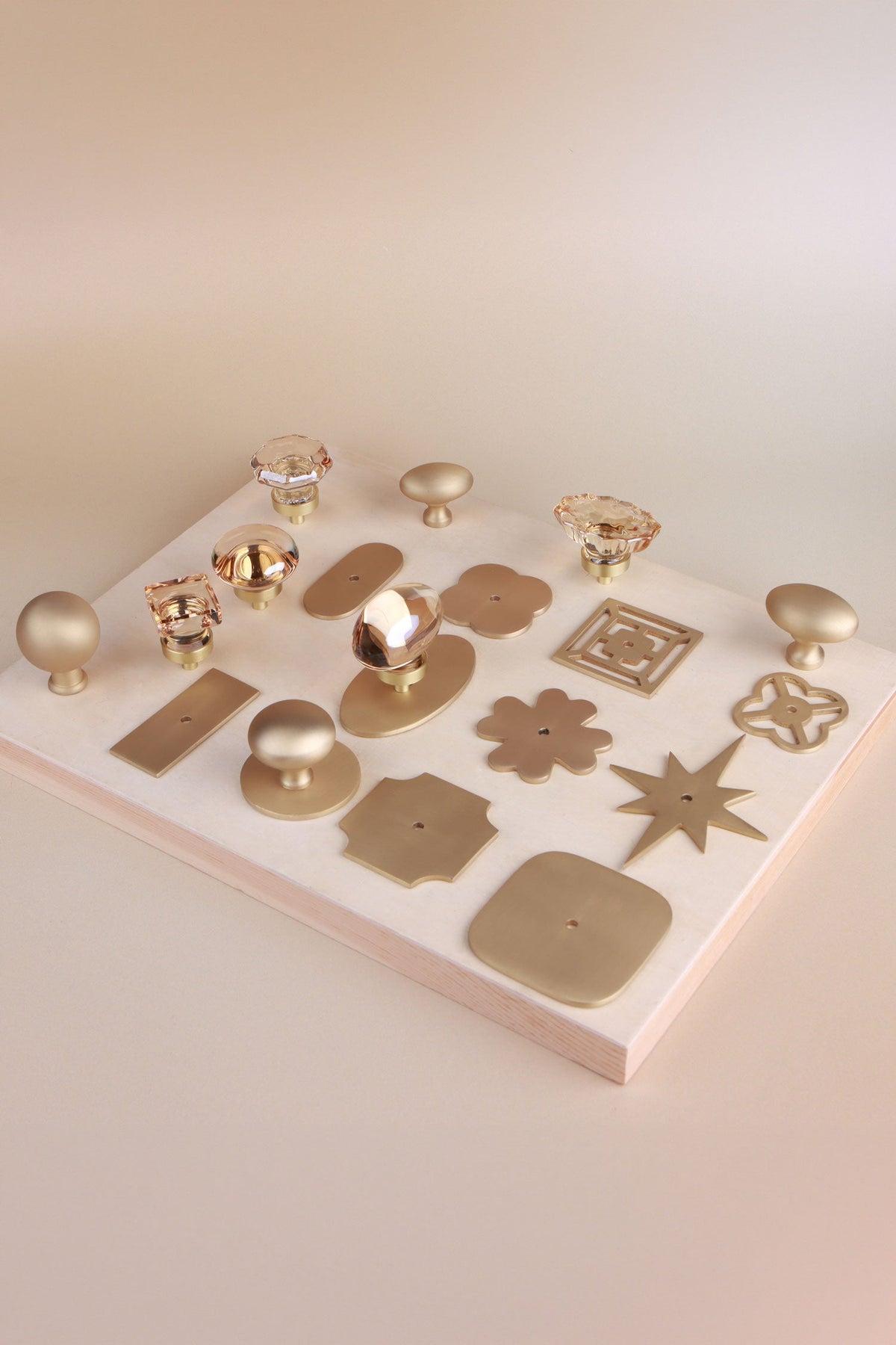 Champagne crystal and satin brass knobs shown fitted on satin brass backplates