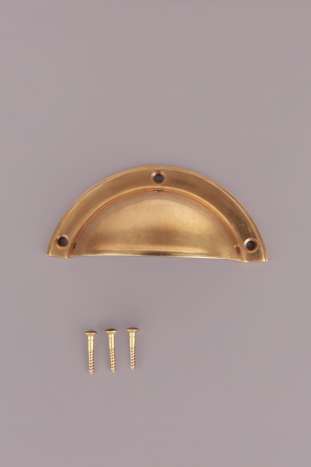 Half moon aged brass cup pull with its screws
