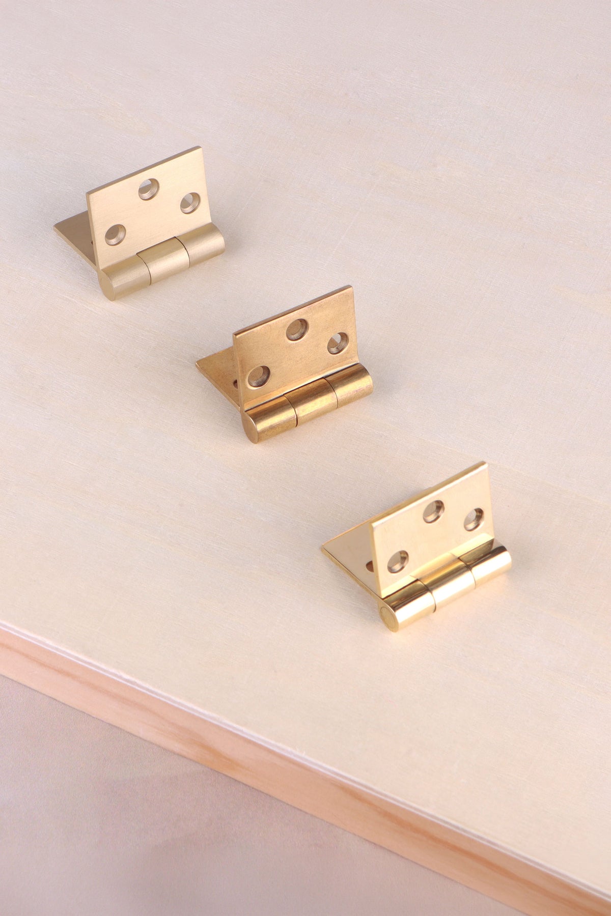 Backflap hinge in polished, aged and satin brass, third view