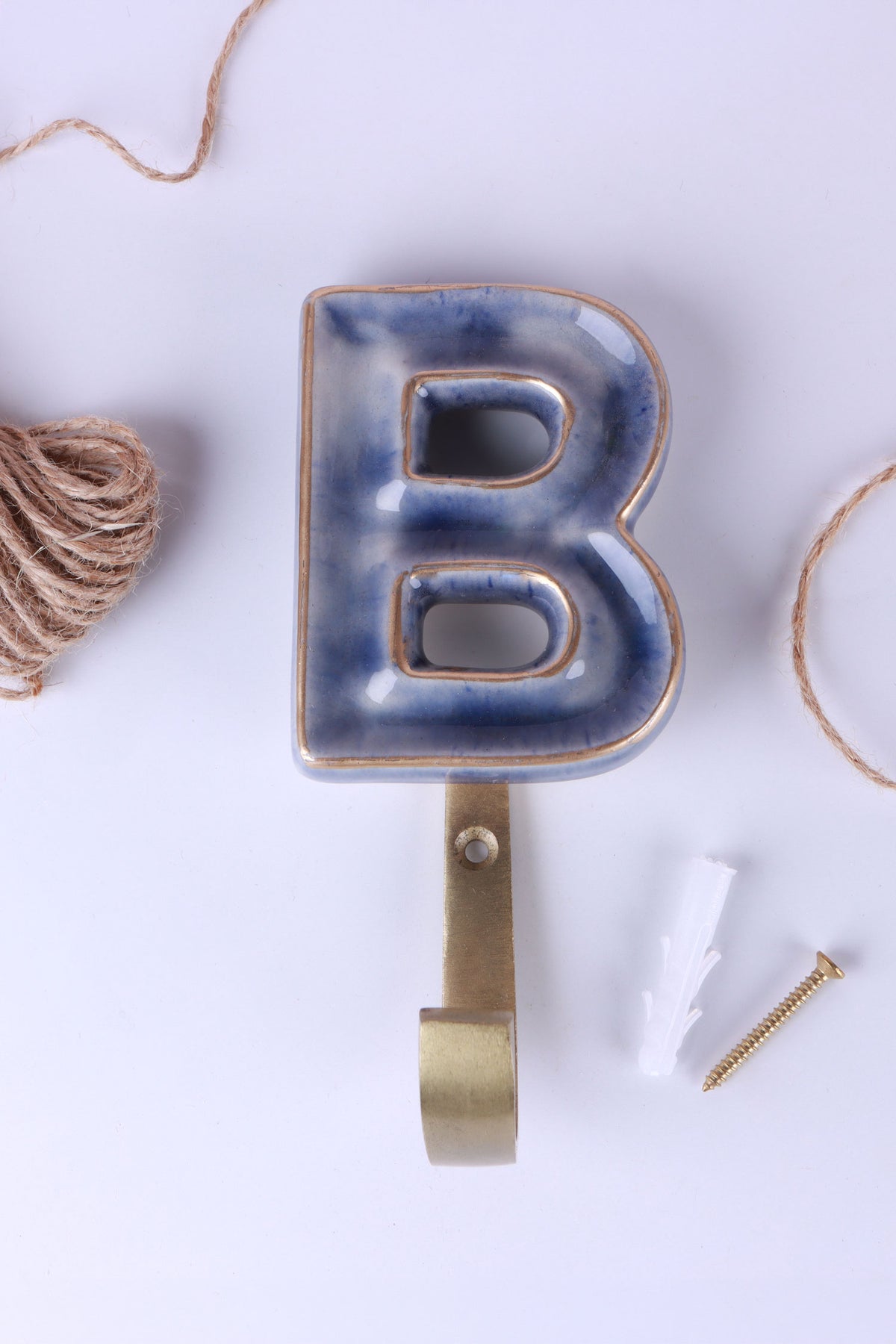 Blue ceramic letter hook B with a gold rim