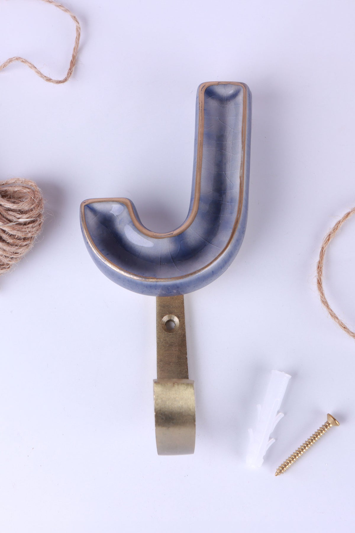 Blue ceramic letter hook J with a gold rim