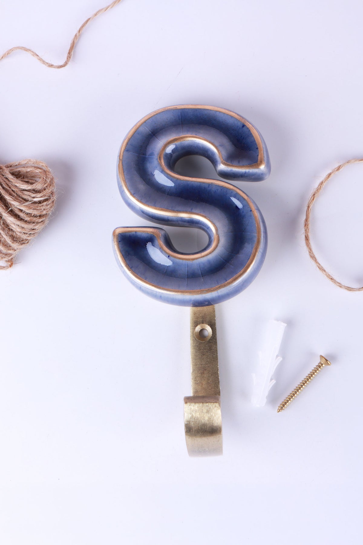 Blue ceramic letter hook S with a gold rim