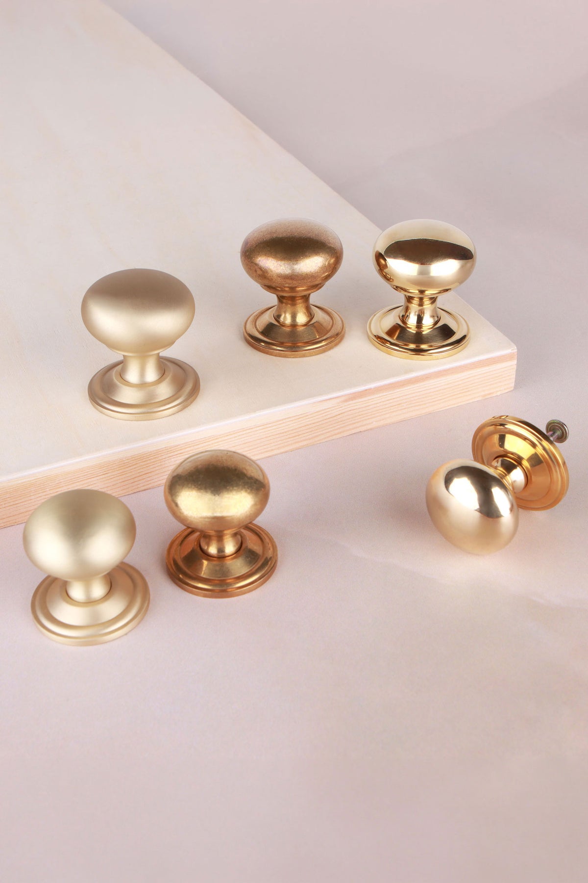 Bun cabinet knob in polished, aged and satin brass, third view