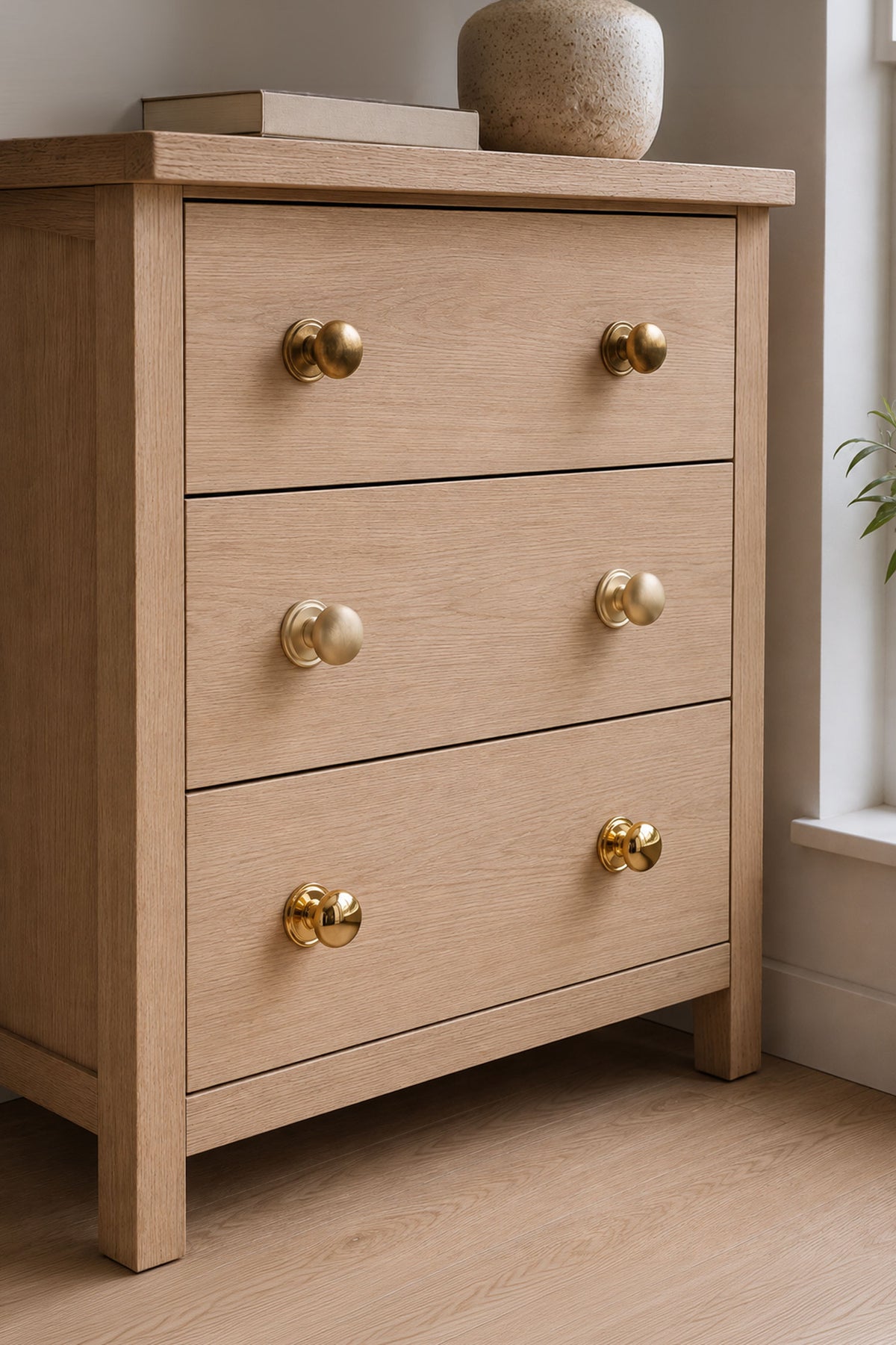 Bun cabinet knob in polished, aged and satin brass