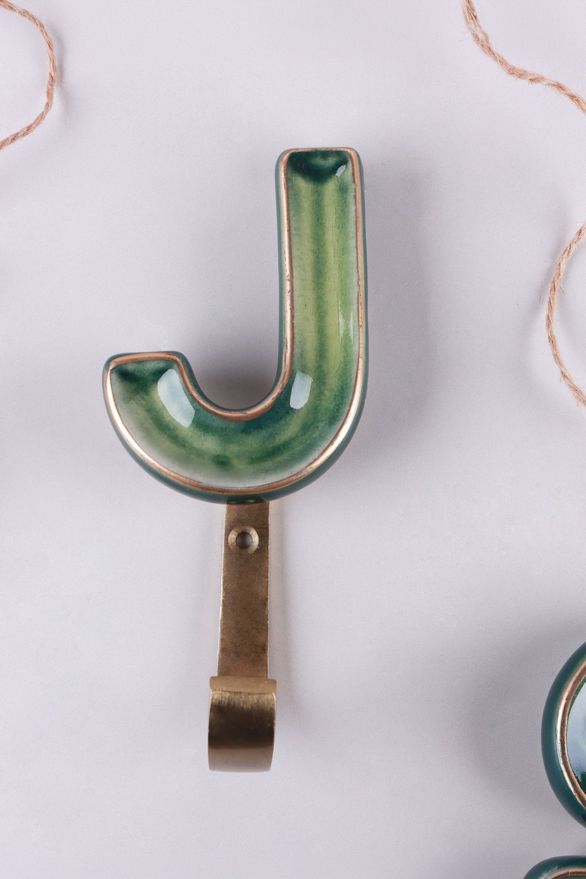Green ceramic letter hook J with a gold rim