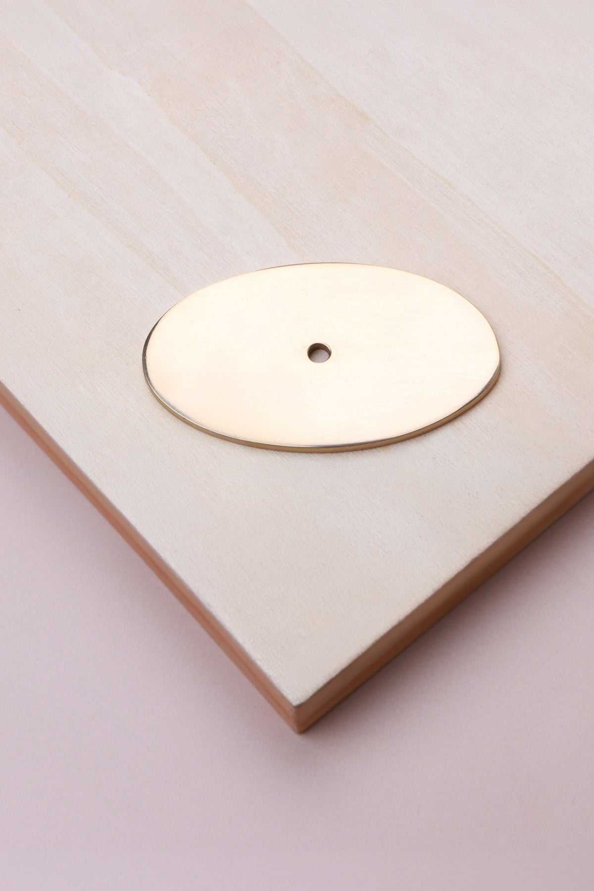 Polished brass oval backplate, 69 x 40mm: solid brass with a 4mm centre hole for the knob bolt