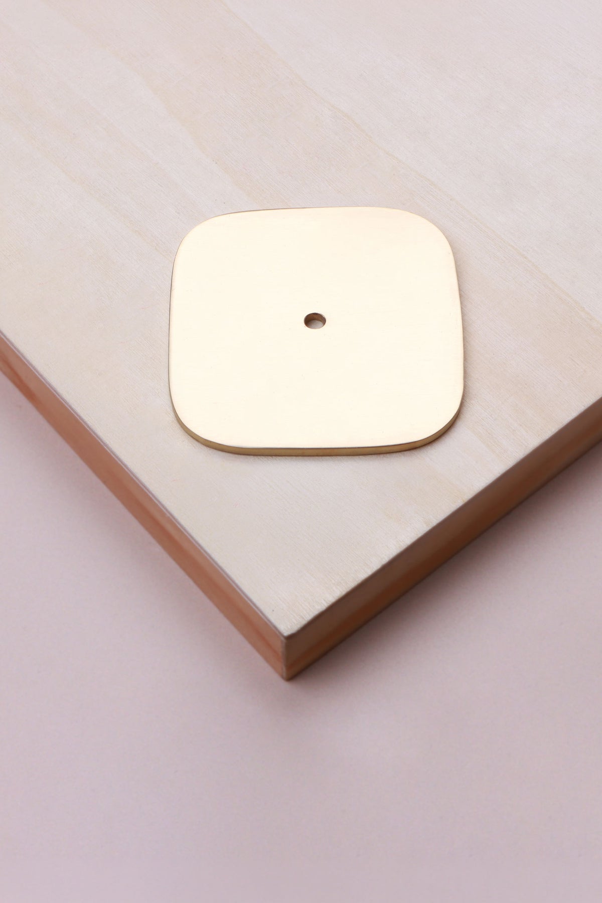 Polished brass squircle backplate, 60 x 60mm with softly rounded sides: solid brass with a 4mm centre hole for the knob bolt