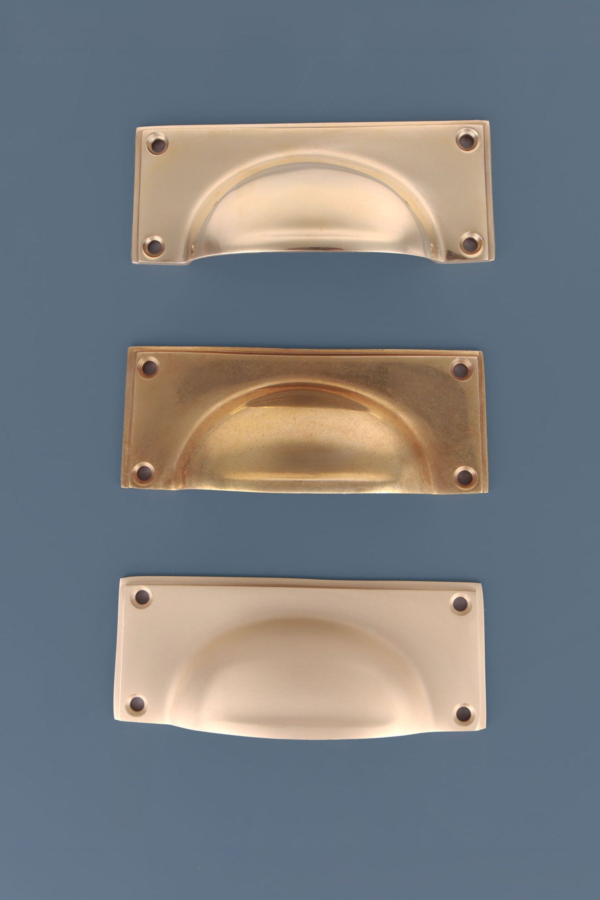 Rounded plate cup pull in polished, aged and satin brass, second view