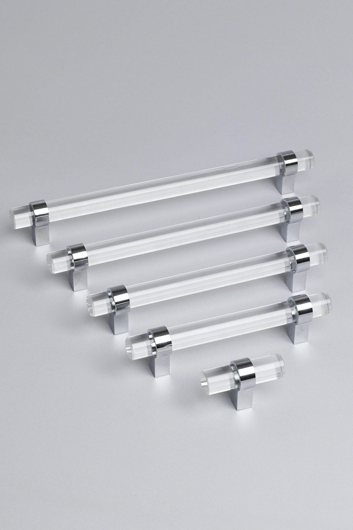 A cabinet pull-vs-knob comparison — Prismé clear faceted glass cabinet pull handle with chrome mounts, set against a painted kitchen cabinet | G Decor