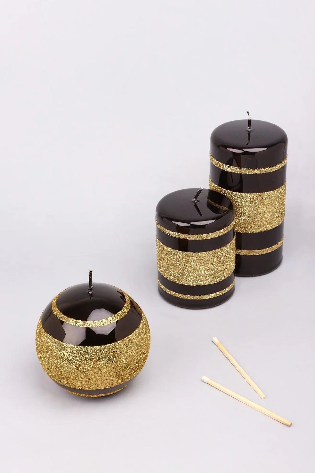 Candle holders and considered candlelight — Clarae mirror glass pillar and ball candles, hand-finished in black and gold stripe | G Decor