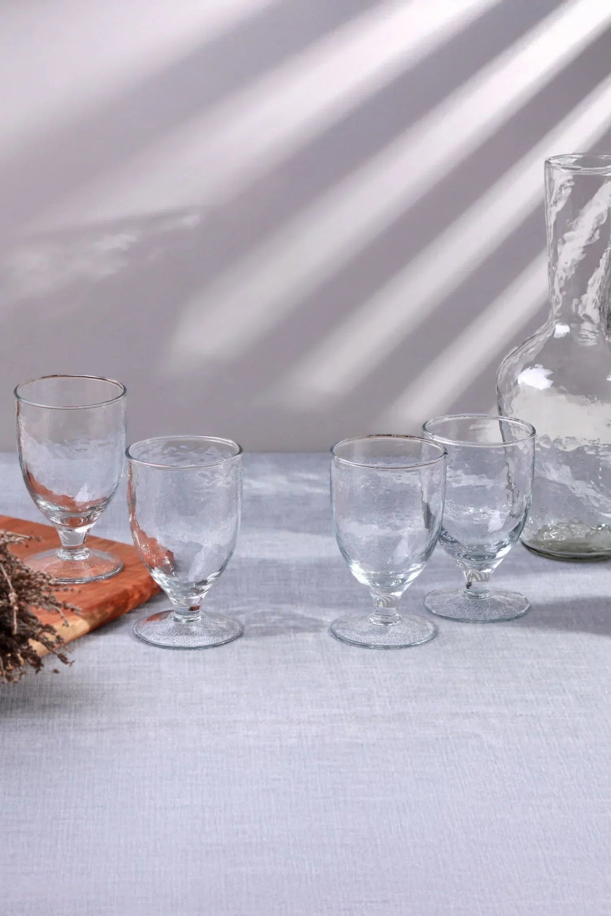 The hostess cabinet — Yaki hammered hand-blown wine goblets, set of four, ready for last-minute guests on a drinks shelf | G Decor