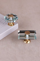 Clear crystal glass cabinet knobs on satin brass bases, in octagon and rectangle shapes