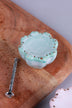 Turquoise scalloped ceramic drawer knob with gold-coloured dots, beside its M4 bolt