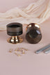 Pair of smokey grey glass cylinder mortice door knobs on polished brass roses, one standing and one on its side, with the square spindles and fixing screws