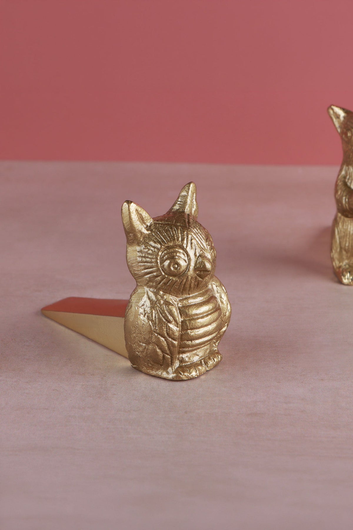 Owl door stopper in polished brass, side view