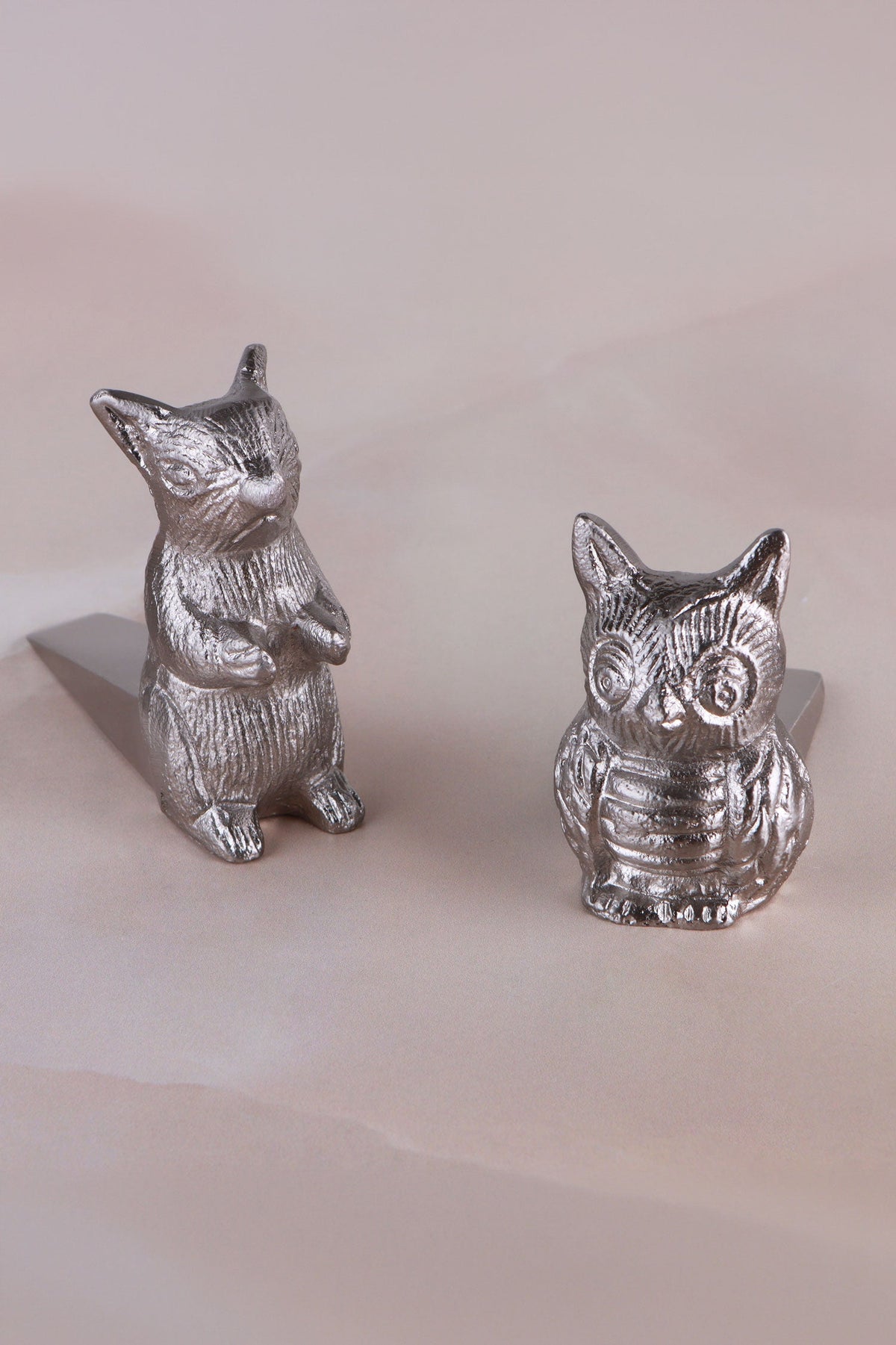 Owl and squirrel door stoppers together, chrome finish