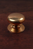 Victorian aged brass cabinet knob, domed on a stepped base, 38mm