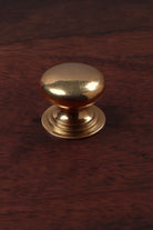 Victorian aged brass cabinet knob, domed on a stepped base, 32mm