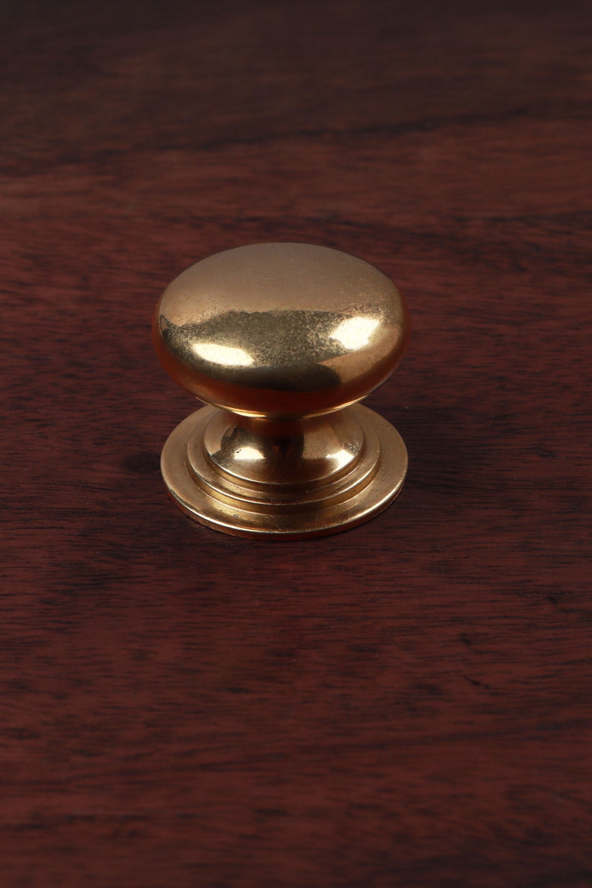 Victorian aged brass cabinet knob, domed on a stepped base, 32mm
