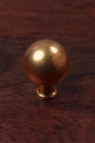 Ball aged brass cabinet knob on a turned collar, 32mm