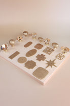 The full set laid out: five champagne crystal knobs, four satin brass knobs and eleven satin brass backplates
