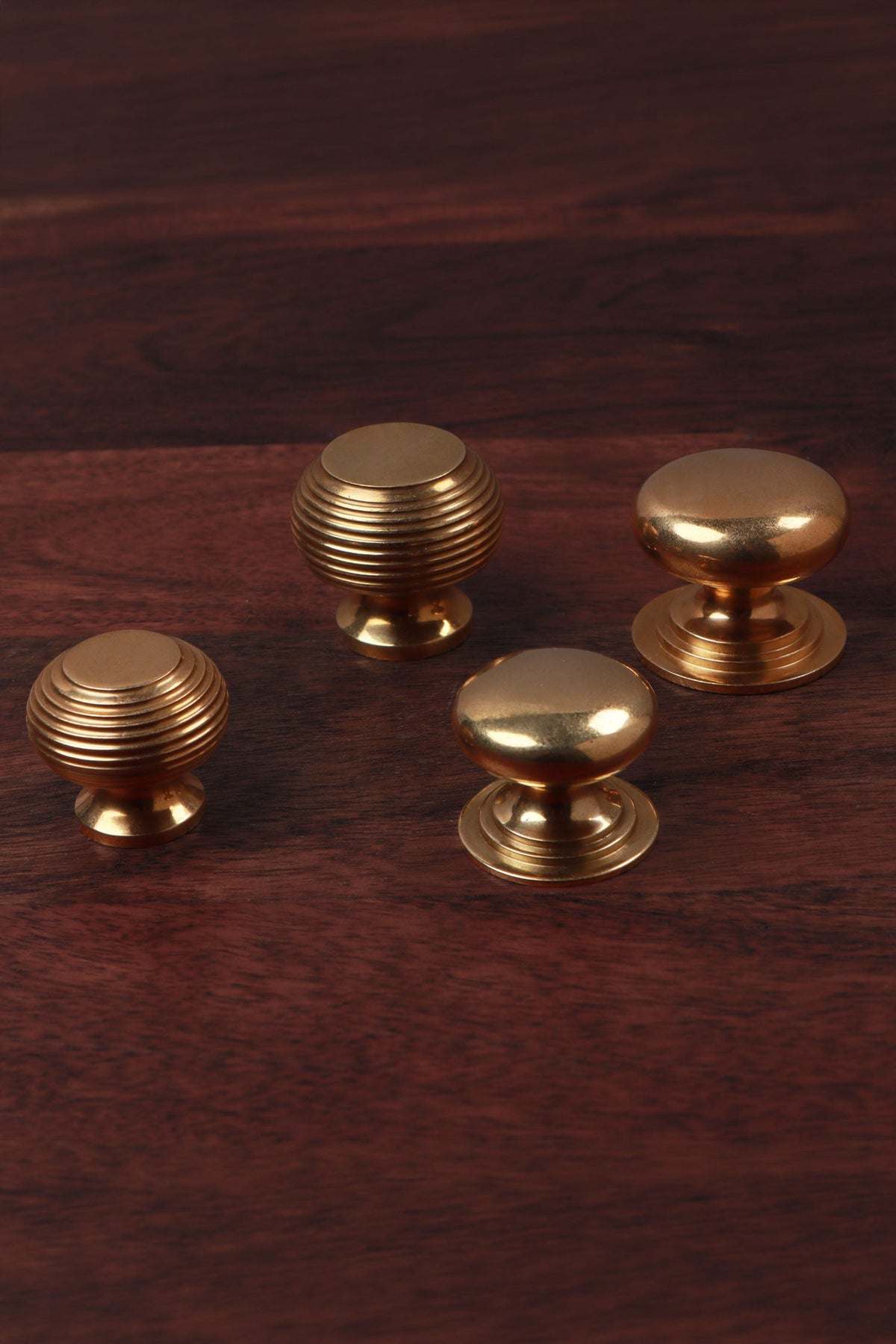 Four solid aged brass cabinet knobs — beehive and victorian, in 32mm and 38mm