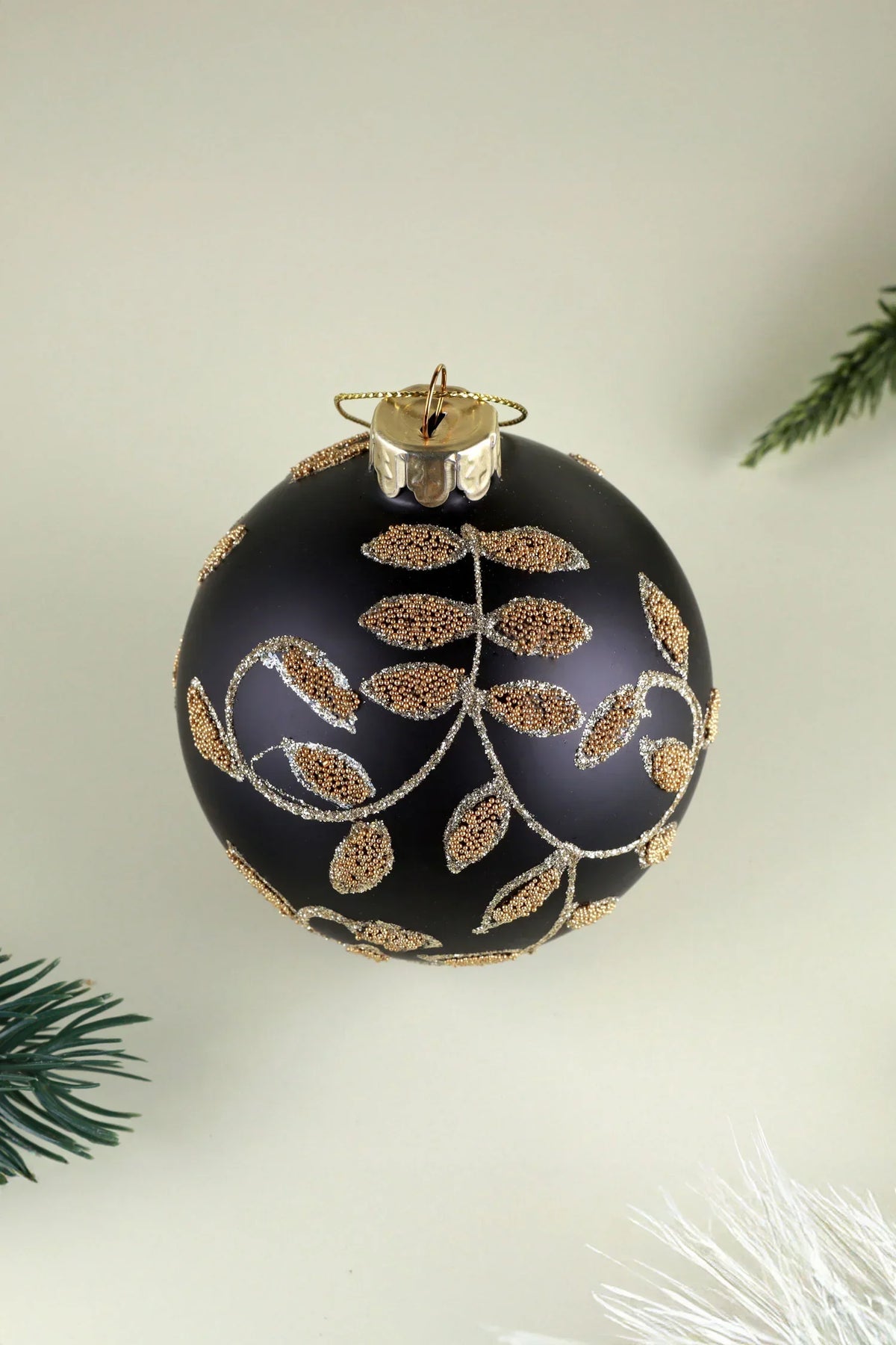 Black and Gold Leaf Hand-Decorated Glass Christmas Bauble — close-up view, G Decor