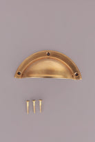 Half moon aged brass cup pull with its screws