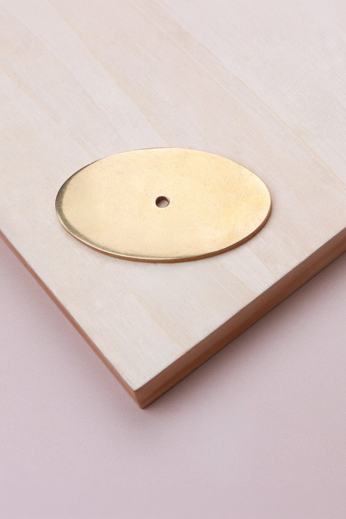 Aged brass oval backplate, 69 x 40mm: solid brass with a 4mm centre hole for the knob bolt