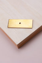Aged brass rectangle backplate, 60 x 25mm: solid brass with a 4mm centre hole for the knob bolt