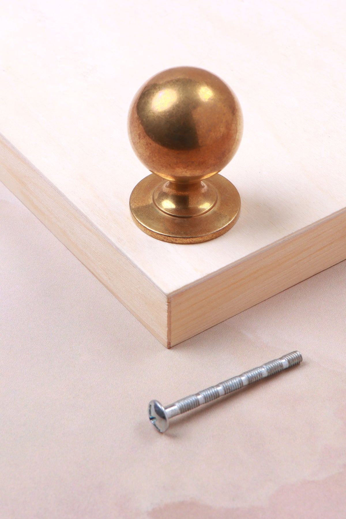 Round cabinet knob in aged brass