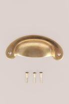 Slim crescent aged brass cup pull with its screws