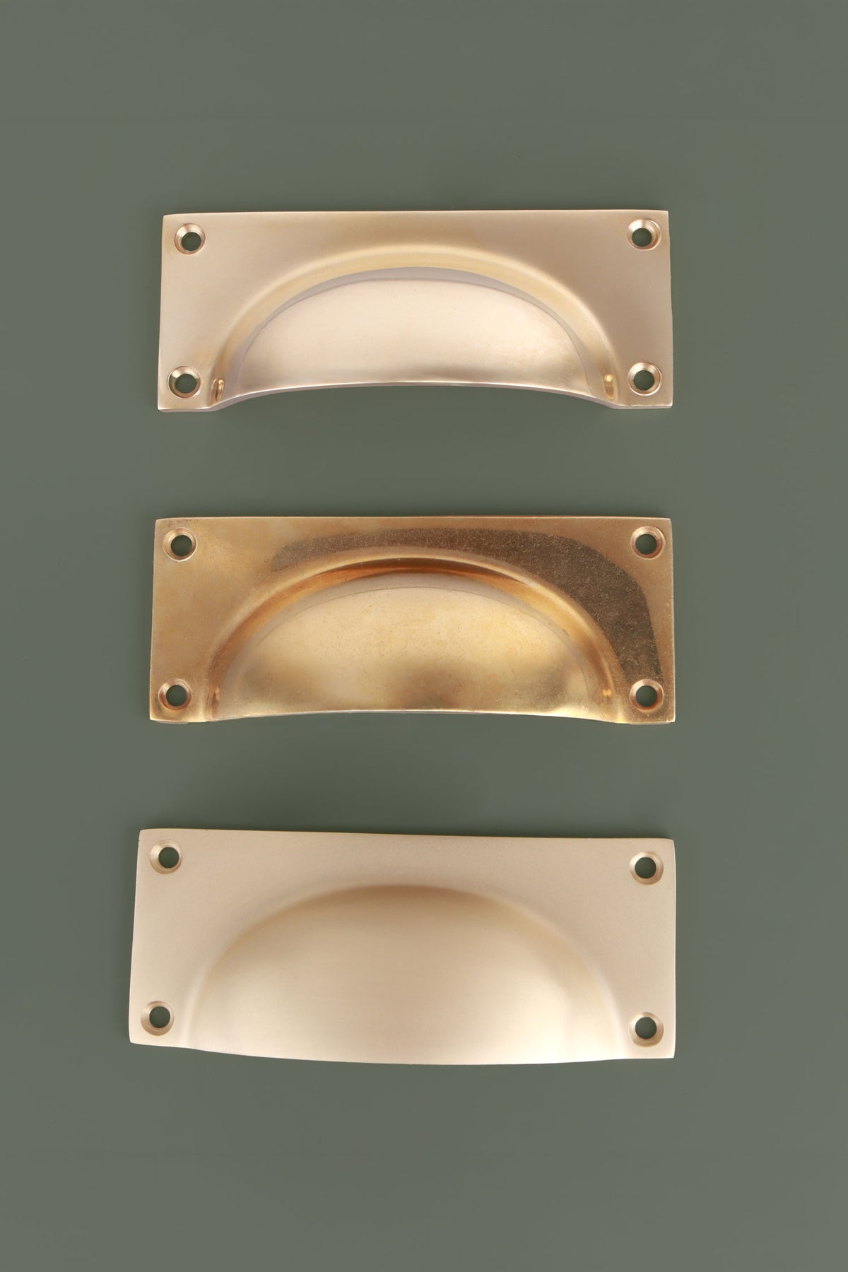 Bevelled plate cup pull in polished, aged and satin brass, third view