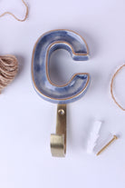 Blue ceramic letter hook C with a gold rim