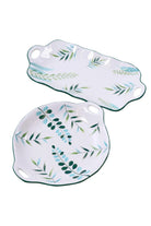 The two leaf serving plates on a white background: the long platter above the round plate