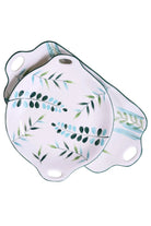 The round leaf plate resting on the long platter, on a white background