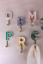 Mixed-colour ceramic letter hooks with gold rims, second view