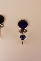 Dark blue ceramic coat hook: deep navy blue disc in a gold-tone frame with a matching dark blue ceramic knob