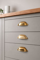 Deep scoop cup pull in polished, aged and satin brass