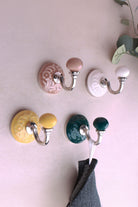 Floral ceramic wall hooks with chrome hooks in cream, yellow, dark green and dusky pink