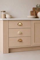 Fluted cup pull in polished, aged and satin brass