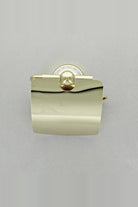 Gold toilet roll holder seen from the front with the cover down