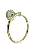 Close-up of the gold towel ring and its white wall plate with a gold Greek key pattern
