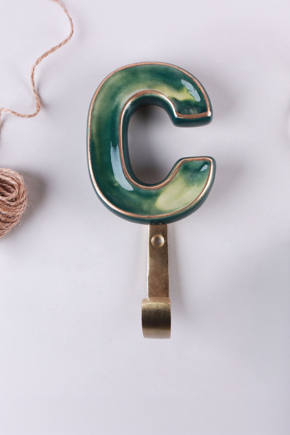 Green ceramic letter hook C with a gold rim