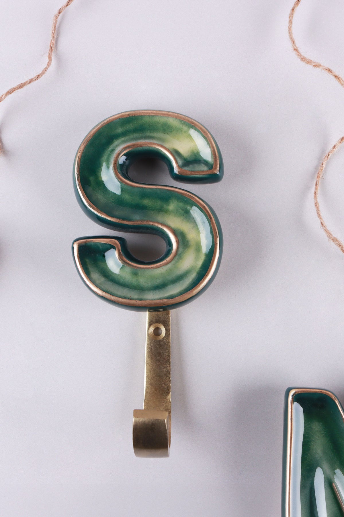 Green ceramic letter hook S with a gold rim