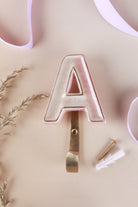 Pink ceramic letter hook A with a gold rim