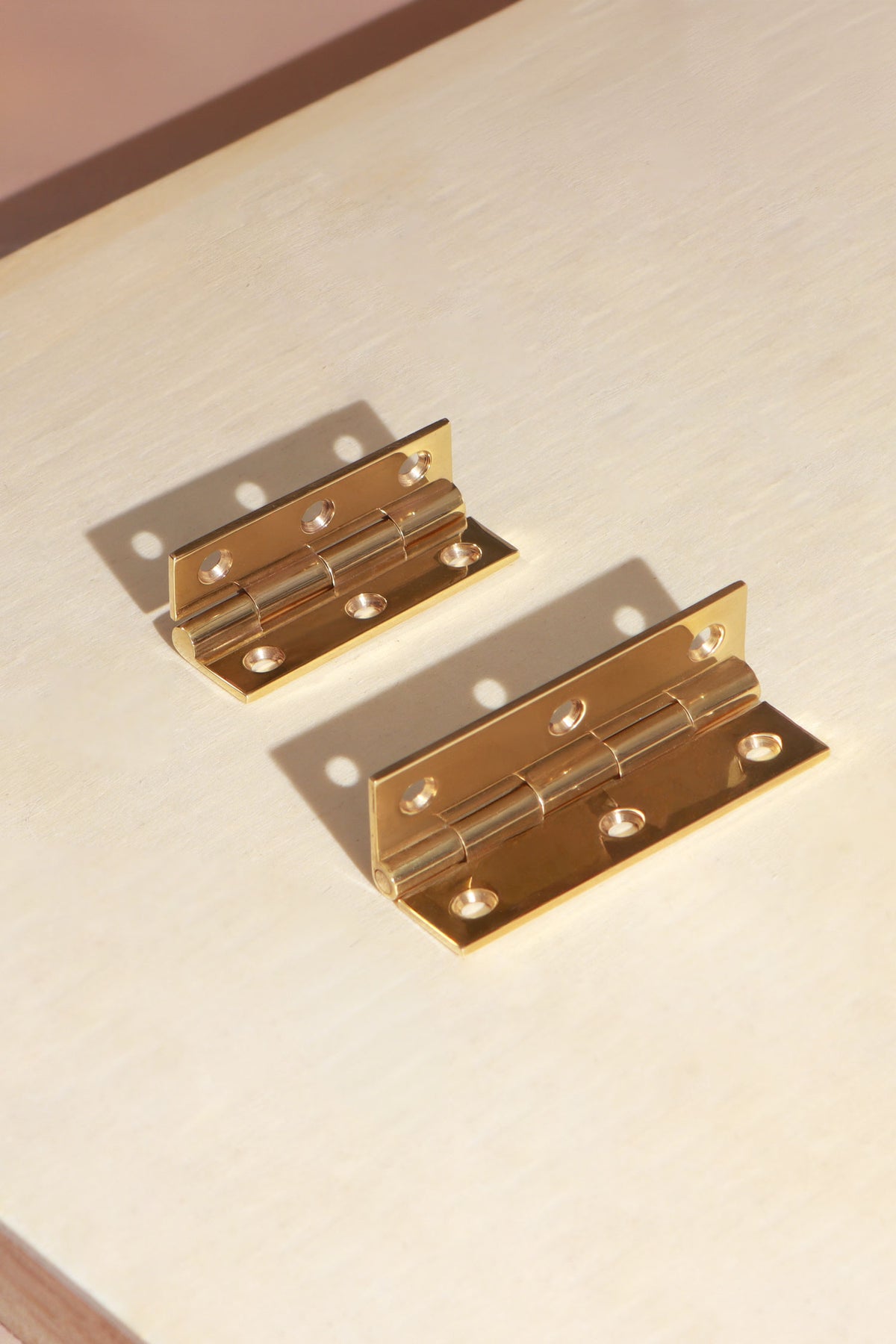 Butt hinge in polished brass, third view