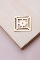Polished brass fretwork backplate, 45 x 45mm, an open square fret: solid brass with a 4mm centre hole for the knob bolt