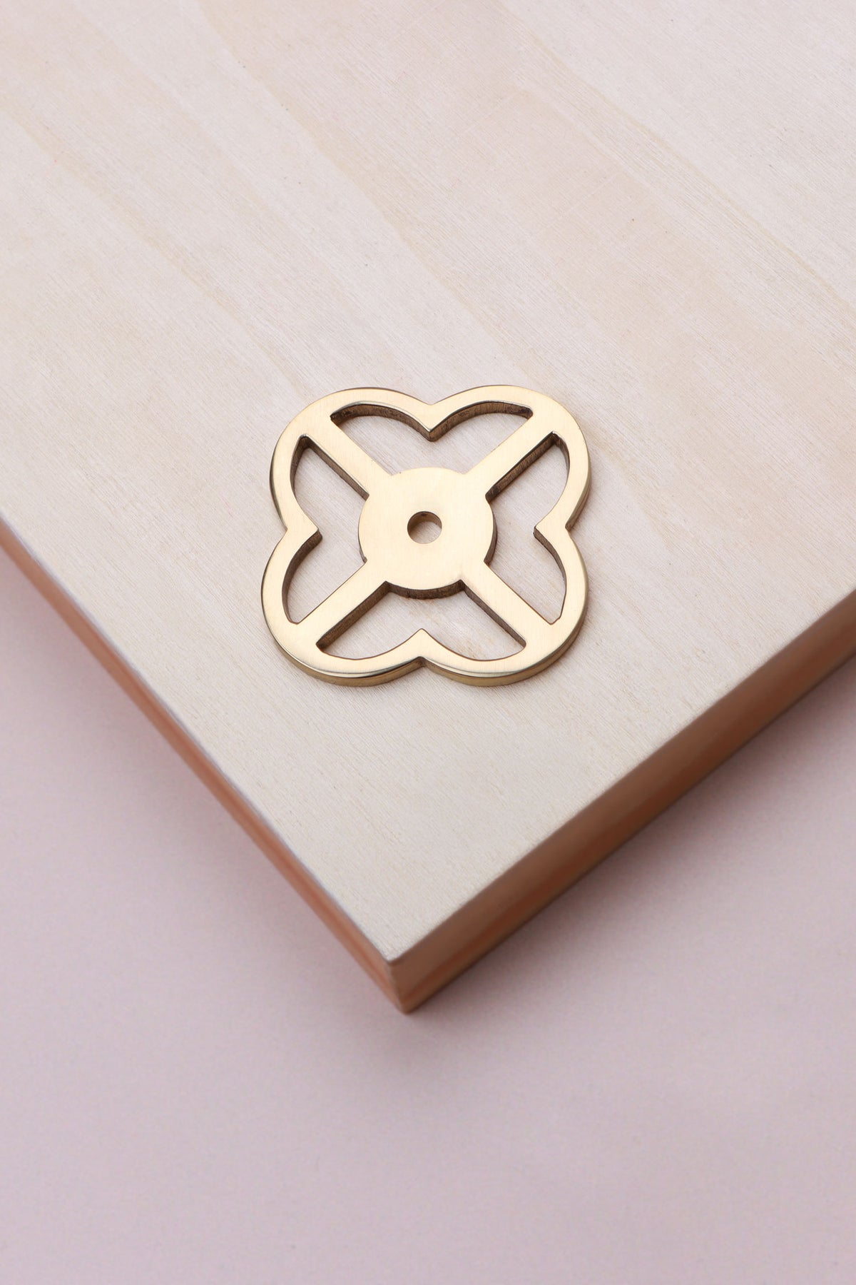 Polished brass pierced backplate, 38 x 38mm, an open quatrefoil: solid brass with a 4mm centre hole for the knob bolt
